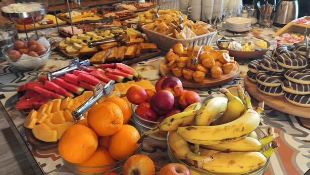 A buffet table with various fruits and pastries. - Vojvoda Putnik (Vranje)
