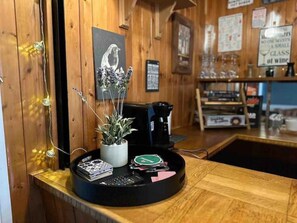 Cozy retreat with a wooden counter, coffee maker, and a potted plant.
