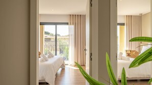A hotel room with a bed, a window with curtains, and a view of a building outside. - Apartment no. 103 (Zonza)