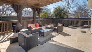 An outdoor patio with wicker furniture, a ceiling fan, and a view of the surrounding area. - Lovely 3 BR Home Only 9 Minutes From Downtown (San Antonio)