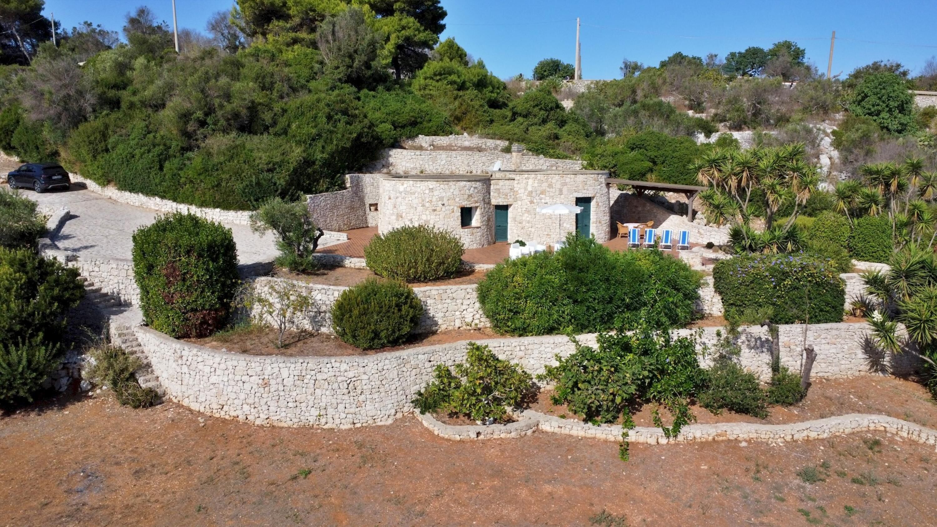 A stone building with a small patio and outdoor seating.
