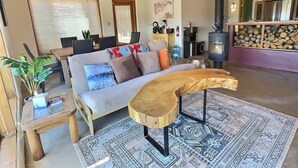 A cozy living room with a sofa, wooden coffee table, and a patterned rug. - Adobe Tranquillo Mountain Views (El Prado)