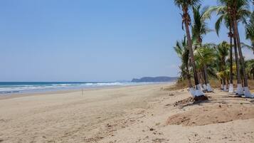 On the beach, sun-loungers, beach towels