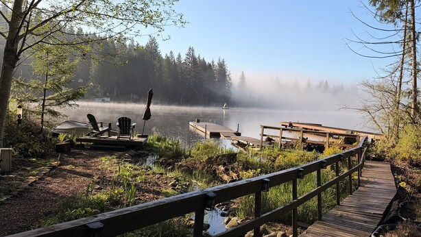 A wooden boardwalk leading to a lake with a misty atmosphere, surrounded by trees and a gazebo. - Beautiful lakefront Casa del Lago on Lake Roesiger (Snohomish)