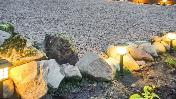 A gravel patio with stone lanterns and a wooden fence in the background. - 2 bedroom accommodation in Ruthwell, near Annan (Ruthwell, near Annan)