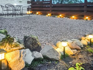 A gravel patio with stone lanterns and a wooden fence in the background. - 2 bedroom accommodation in Ruthwell, near Annan (Ruthwell, near Annan)
