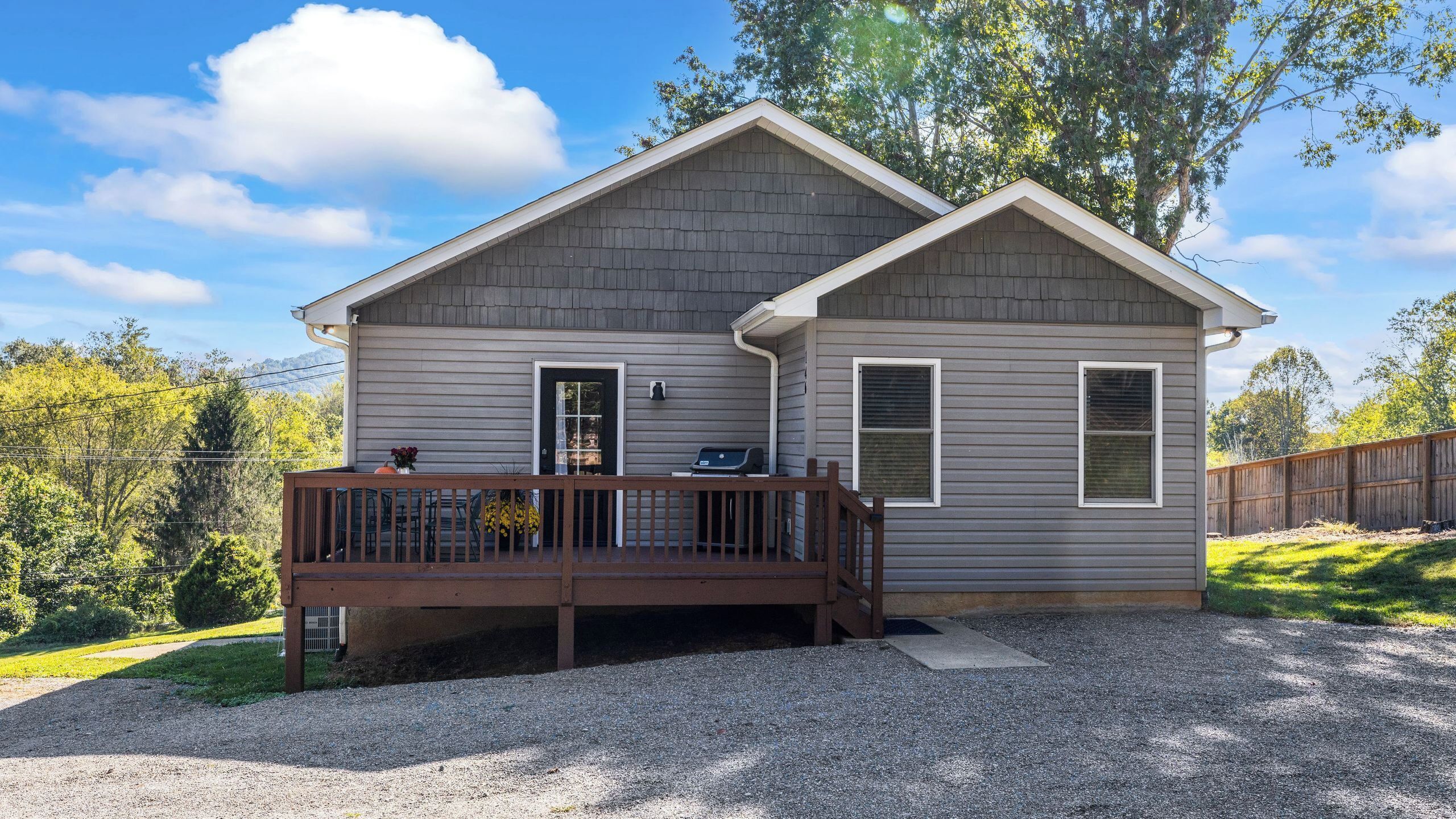 A single-story house with a porch, a door, and a window.