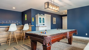 A pool table with balls, a white chair, a pool table with balls, a pool table with balls, a pool table with balls, a pool table with balls, a pool table with balls, a pool table with balls, a pool table with balls, a pool table with balls, a pool table with balls, a pool table with balls, a pool table with balls, a pool table with balls, a pool table with balls, a pool table with balls, a pool table with balls, a pool table with balls, a pool table with balls, a pool table with balls, a pool table with balls, a pool table with balls, a pool table with balls, a pool table with balls, a pool table with balls, a pool table with balls, a pool table with balls, a pool table with balls, a pool table with balls, a pool table with balls, a pool table with balls, a pool table with balls, a pool table with balls, a