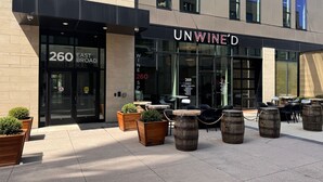 A modern building with a storefront labeled "UNWINED" at 260 East Broad Street. - Rare Luxury: Apartment with Unparalleled Elegance (Rochester)