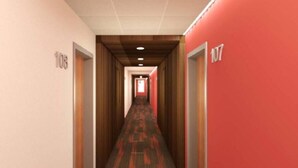 A hotel corridor with wooden paneling, red carpet, and doors numbered 108 and 107. - Bright, Colorful & Convenient 1-Bedroom Apartment (Rochester)