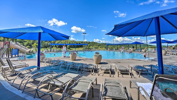 A pool area with blue umbrellas, lounge chairs, and a water slide. - Galena Townhome w/ Deck & Golf Course View! (Galena)