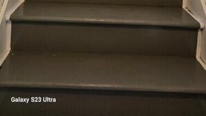 A staircase with a handrail leading to a door. - Get More Bang For Your Buck! (Wichita)