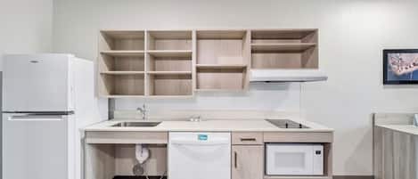 A modern kitchen with a built-in dishwasher, a microwave, and a refrigerator.