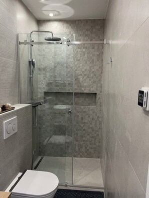 A modern bathroom with a glass-enclosed shower, a toilet, and a control panel. - Villa Nova Excellence II (Novalja)