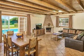 Cozy living area with a fireplace, television, and dining space.