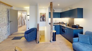 A modern apartment with a kitchen, living area, and a hallway leading to another room. - L'Escale du Vieux Port 4P - Closed Garage - Sauna - Air Conditioning (Honfleur)