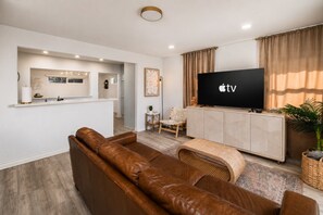 A modern living room with a leather sofa, a flat-screen TV, and a minimalist design. - Downtown La Mesa gem (La Mesa)