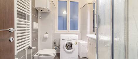 Apartamento premium | Banheiro | Chuveiro, secador de cabelo, toalhas de banho, papel higiênico