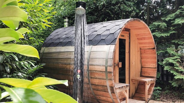 A wooden sauna with a sloped roof and a waterfall feature. - Nice home in Rheezerveen with sauna (Rheezerveen)