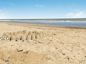 A sandy beach with a sandcastle structure. - 4 bedroom accommodation in Eccles on Sea (Eccles on Sea)