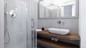A modern bathroom with a glass shower enclosure, a white sink, and a large mirror. - Italianway - Sigieri 10 (Milan)