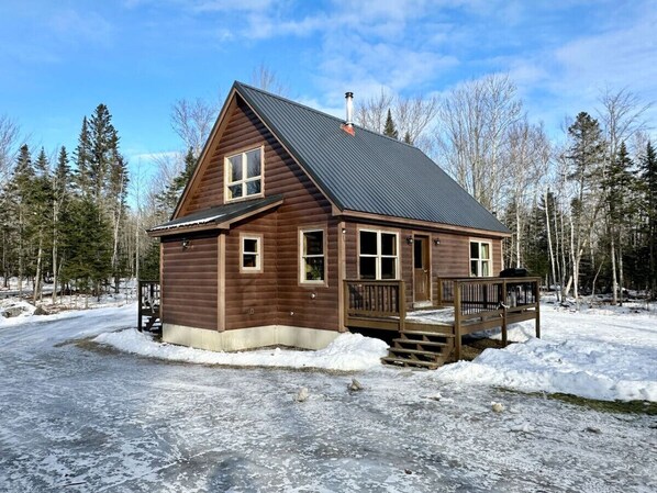 A wooden cabin with a metal roof, a porch, and a chimney. - Caddis Ridge Camp|West Forks with Trail Access (West Forks)