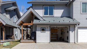 A two-story house with a garage, a covered porch, and a small attached garage. - Cozy Hailey Haven: Sun, Ski, Work, & Play at Your Doorstep (Hailey)