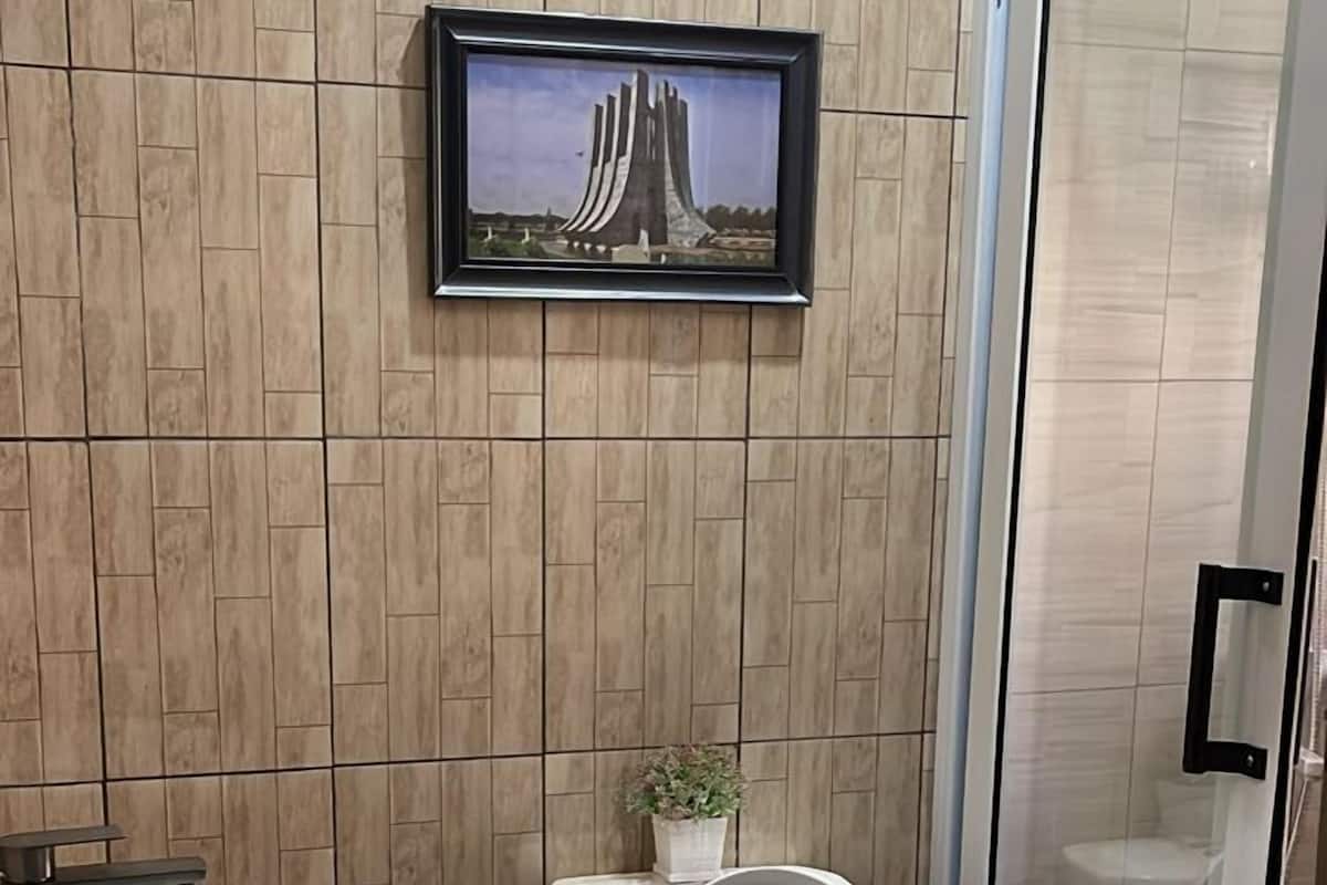A bathroom with a toilet, sink, and shower.