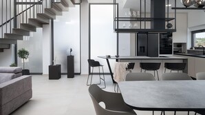 A modern interior with a staircase, dining area, and kitchen. - Stunning home in Vrsi with sauna (Vrsi)