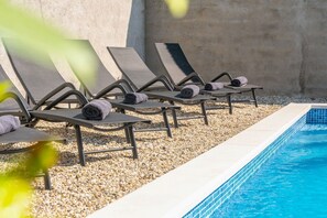 A poolside area with lounge chairs and towels.