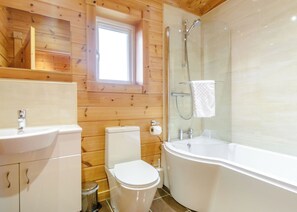A bathroom with a toilet, sink, and bathtub.