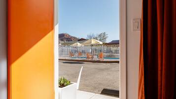 Desk, laptop workspace, blackout drapes, iron/ironing board