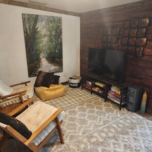 Smart TV, fireplace, table football, books
