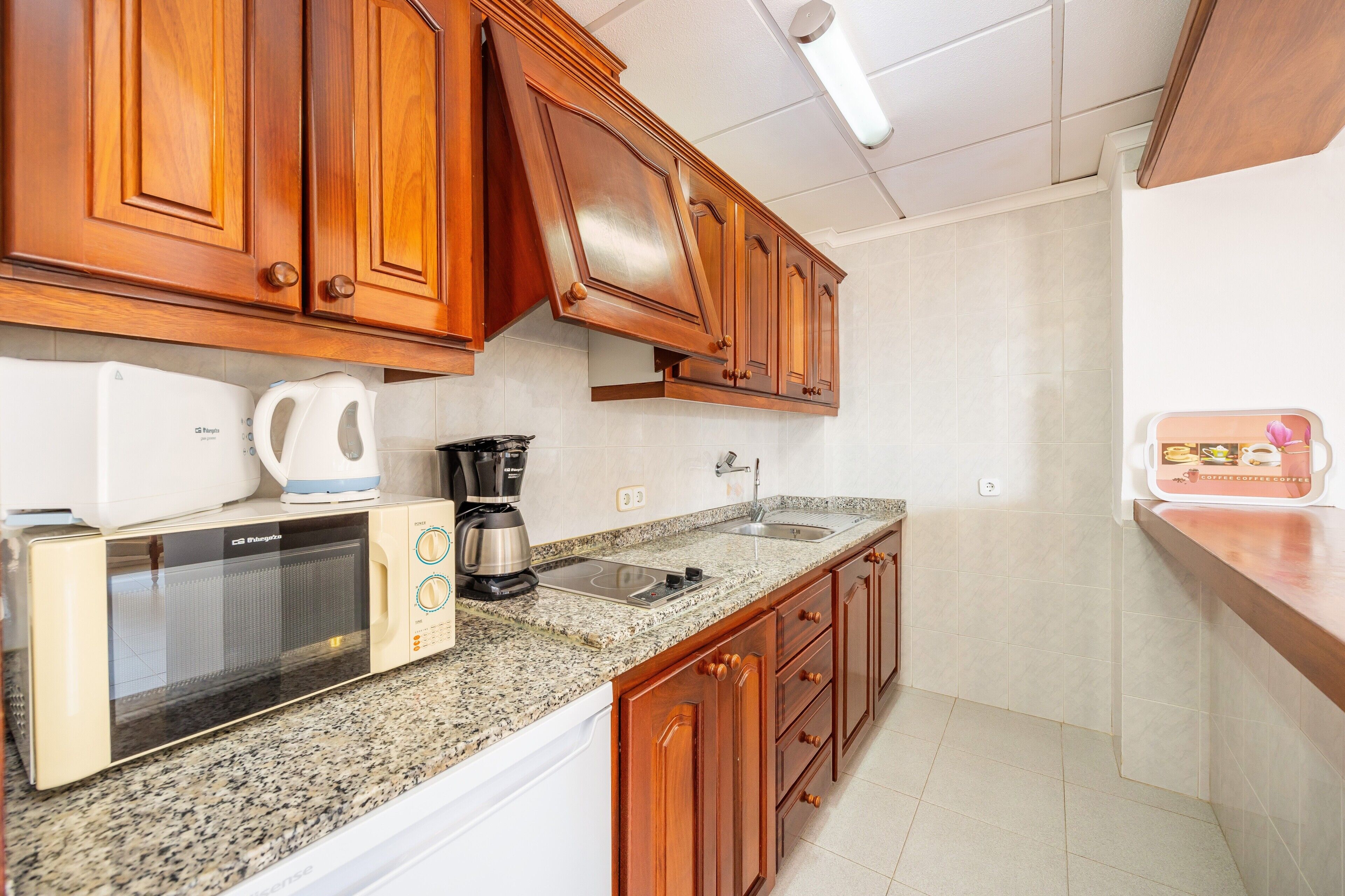 Fridge, microwave, stovetop, coffee/tea maker