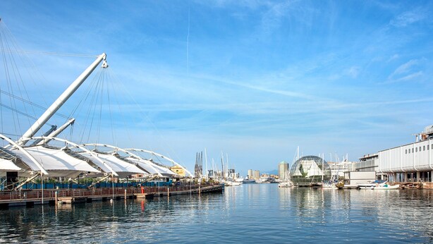 A waterfront marina with boats, a large white structure with a dome, and a modern building with a curved facade. - Apartment 'Ohana Bnb' with Wi-Fi (Genova)