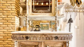 A vintage-style counter with ornate carvings, a vintage telephone, and a framed menu. - Designer Country House Near the Sea (La Nucia)