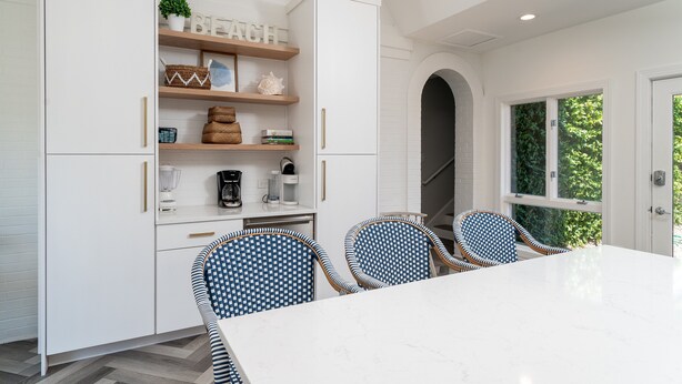 A modern kitchen with white cabinetry, a marble countertop, and blue patterned chairs. - Fabulous Location! Sleeps 12! Walk to Club/Beach! Amenity access included (Seabrook Island)