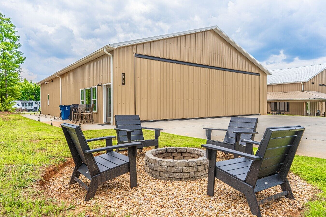 A building with a large open patio area, outdoor seating, and a fire pit.