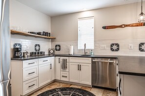 Fridge, microwave, coffee/tea maker, cookware/dishes/utensils