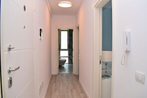 Enter a secure space with a door featuring a keyhole and handle, and access to a room with a window and communication facilities.