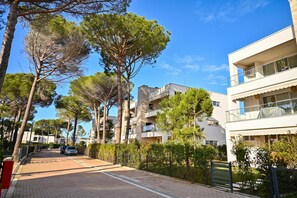 A residential street with modern buildings, a paved road, and trees. - San Pietro Serenity Home, Lalzit Bay, Albania (Lalzit Bay)