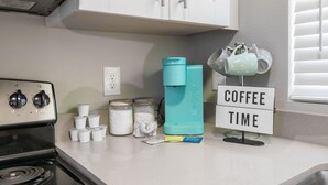 A kitchen counter with a coffee maker, a sign that says "COFFEE TIME," and a stack of white cups. - Cozy Downtown, Montrose Studio!
Free parking ! (Houston)