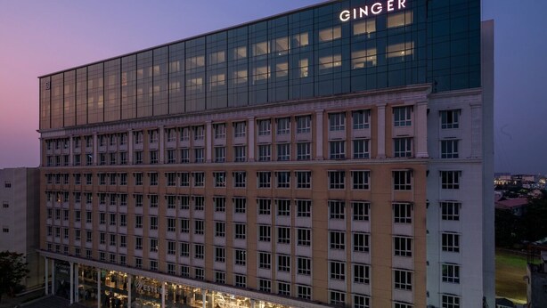 A multi-story hotel with a modern glass facade and a prominent 'GINGER' sign. - Ginger Nagpur Airport Road (Nagpur)