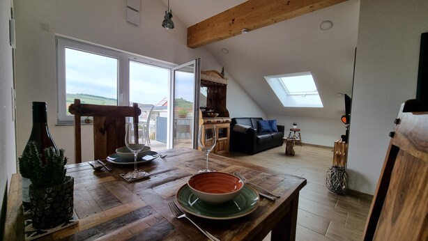 Un loft amplio con comedor, sofá y cocina.