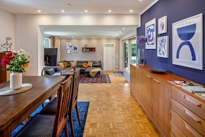 A modern kitchen with a dining area, wooden cabinets, and a large window. - Spacious Holiday Home in Northern Hesse with Private Terrace, Garden & Wi-Fi (Homberg (Efze))