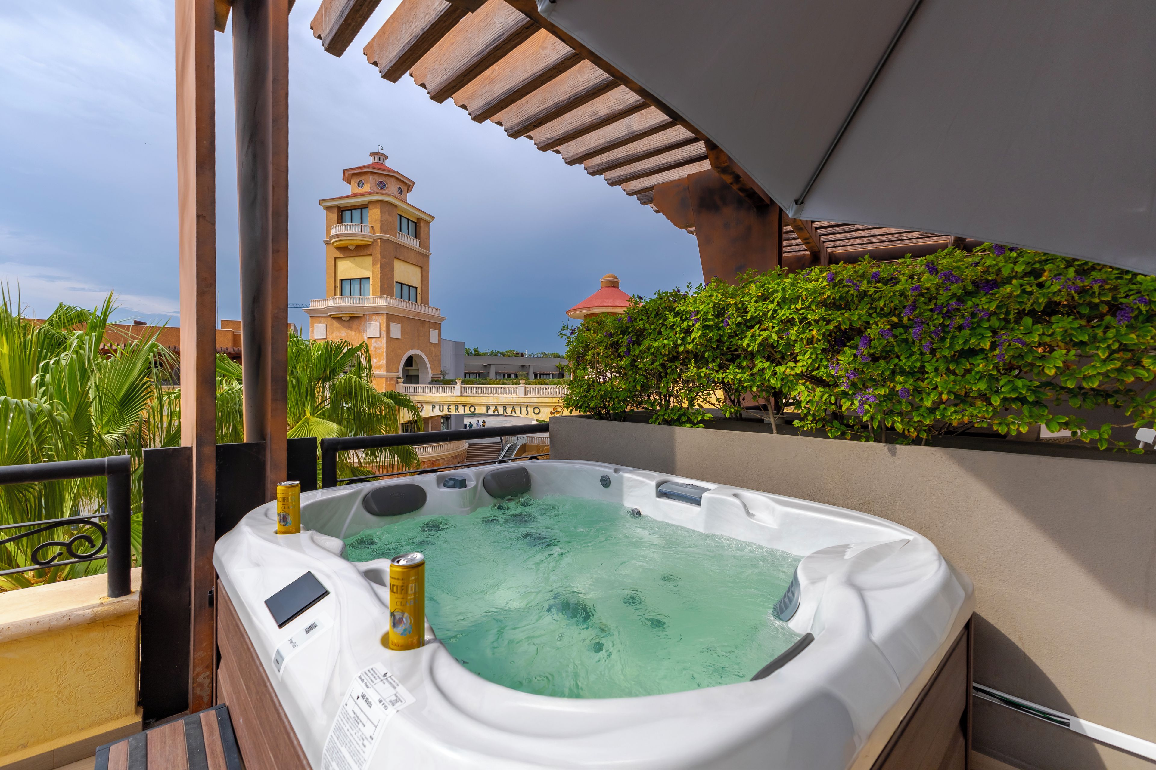 A hot tub with a view of a building with a clock tower.