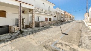 A quiet street with white buildings, a clear sky, and a visible streetlight. - 3795 Joy R - Appartamento 3 by Barbarhouse (Manduria)