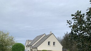 A gated driveway leading to a house with a number 14 sign, a security camera, and a warning sign on the wall. - A guest room for rent (possibility of renting 2 rooms) (Vienne en val)