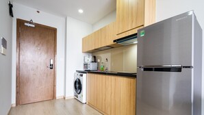 Standard Apartment, City View | Private kitchen | Fridge, microwave, cookware/dishes/utensils, cleaning supplies - Fusion RiverGate Apart Infinity Pool (Ho Chi Minh City)