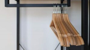 A metal rack with wooden hangers.